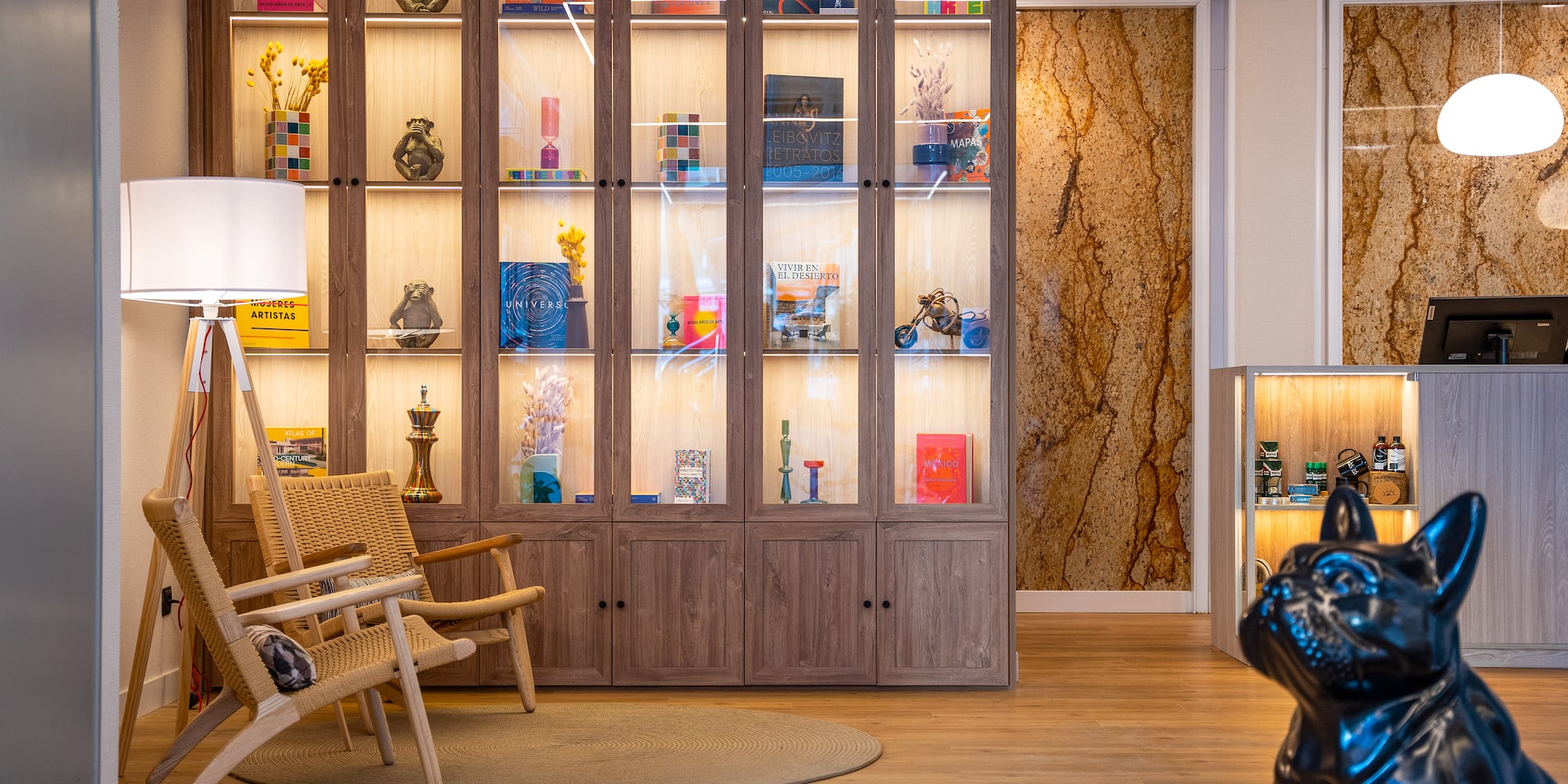 a room with a glass shelf and a chair