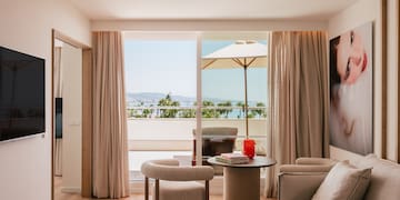 a living room with a table and chairs