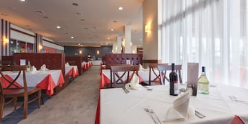 a restaurant with tables and chairs