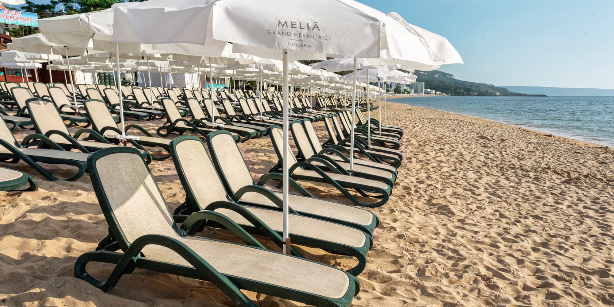 a beach with chairs and umbrellas