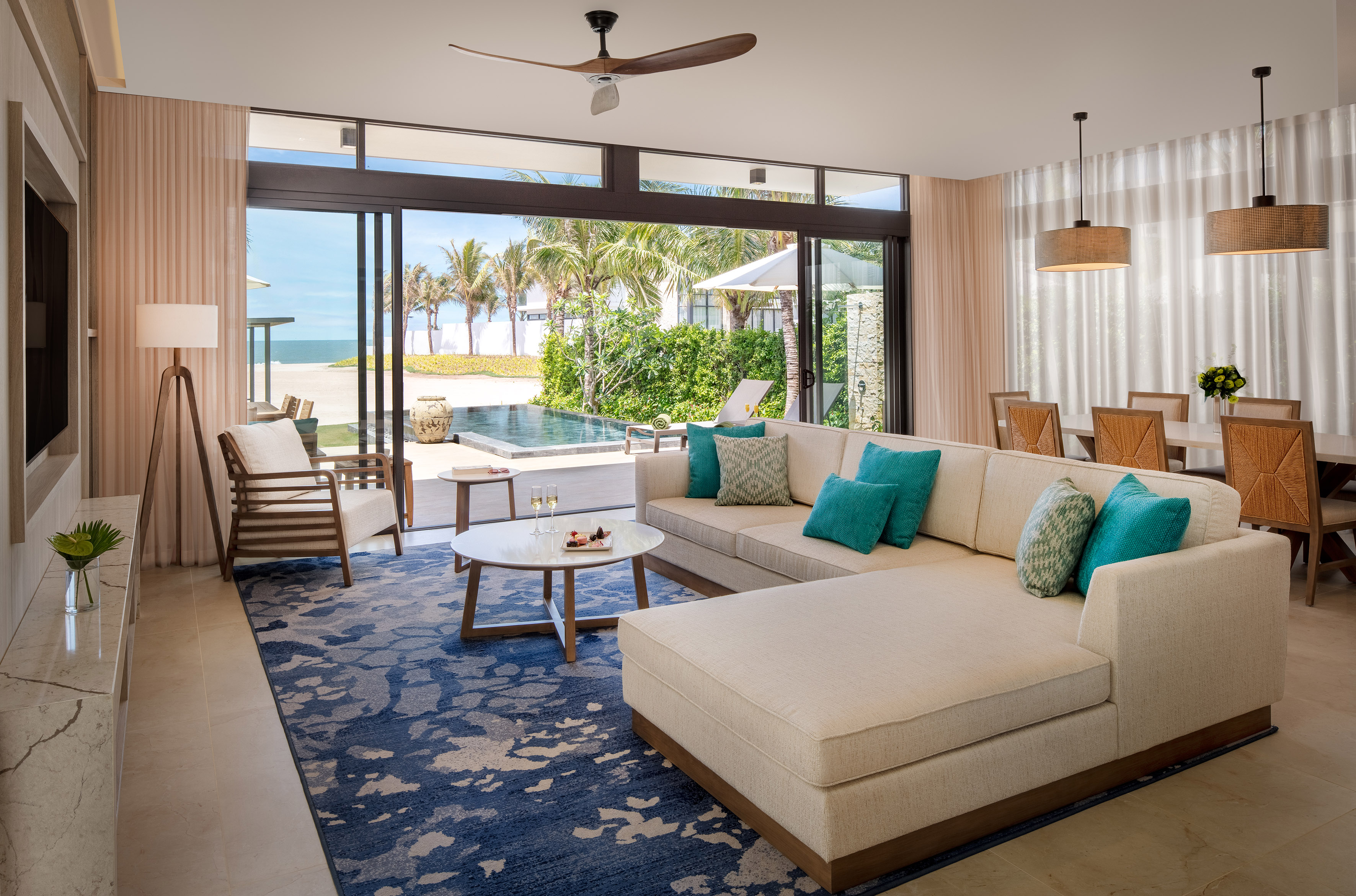 Luxury beach villa living room with private pool and ocean views.