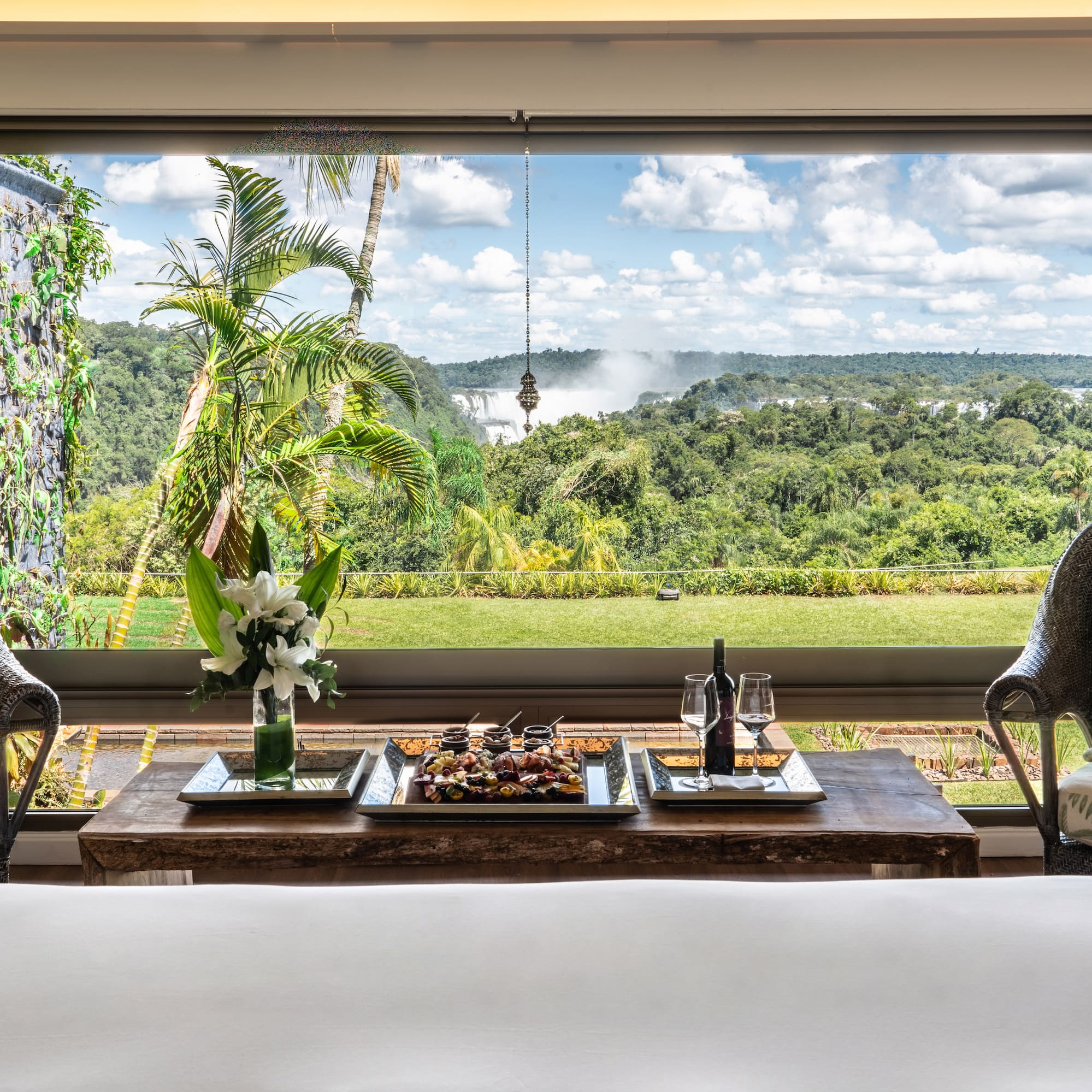 a table with food and wine in front of a window