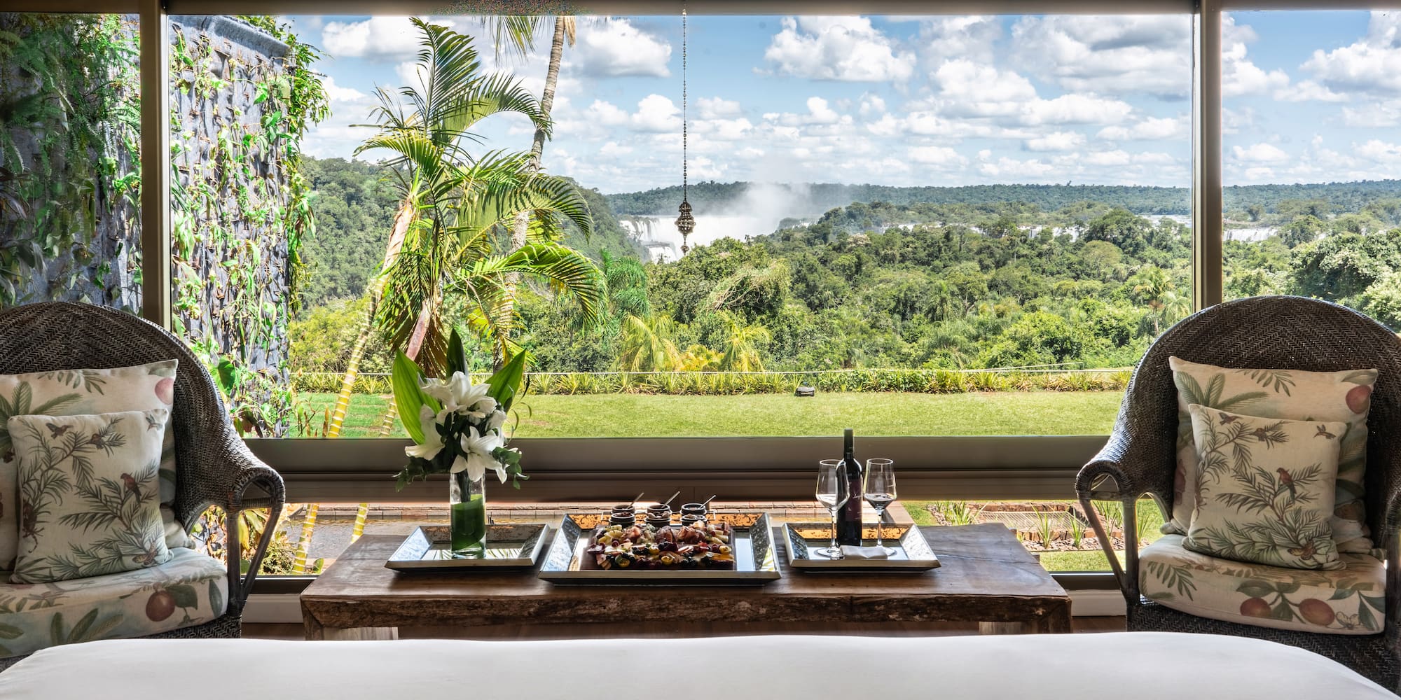 a table with food and wine in front of a window