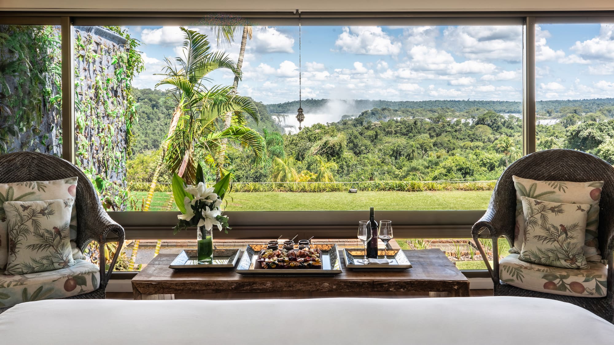 a table with food and wine in front of a window