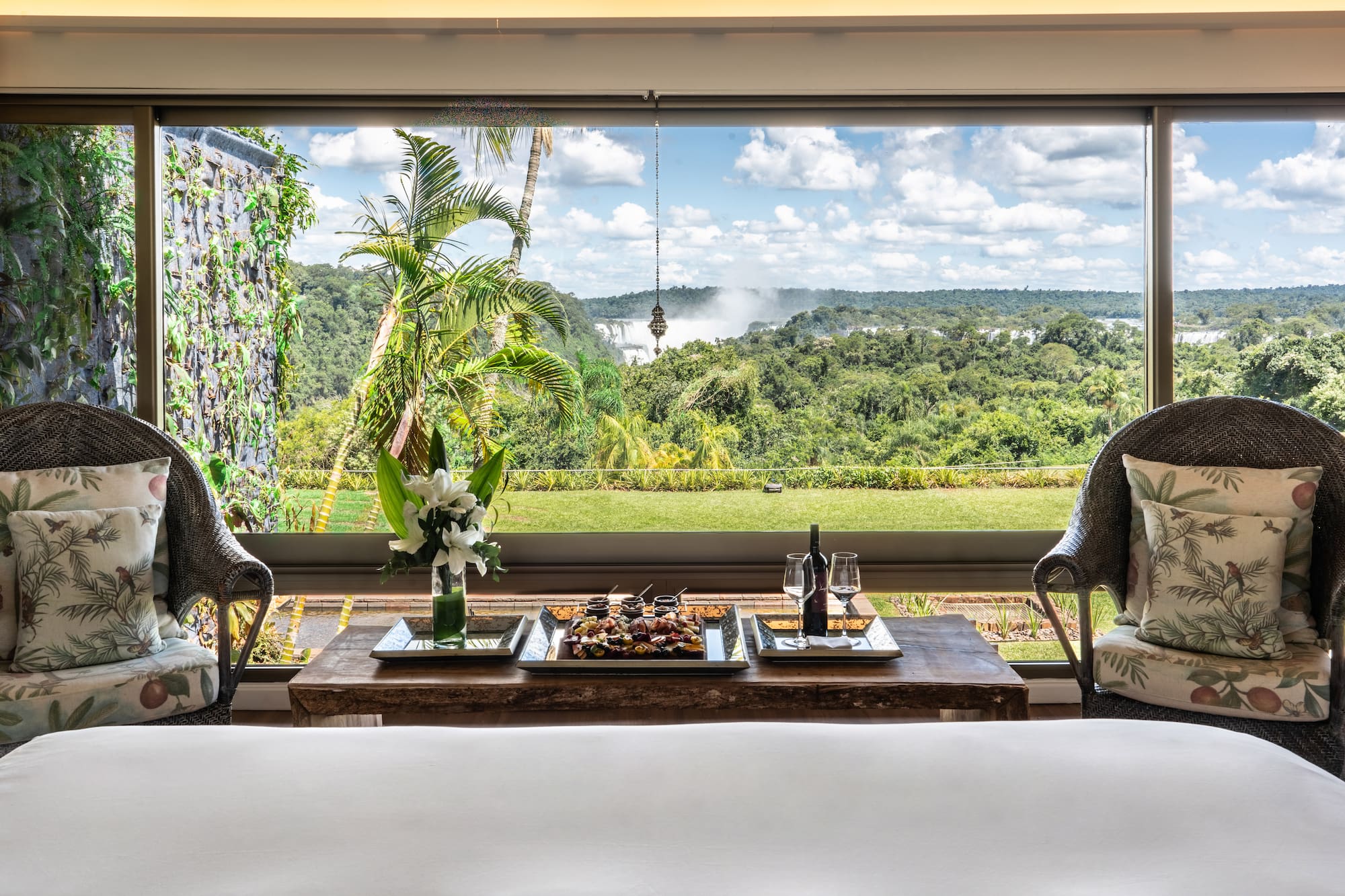 a table with food and wine in front of a window
