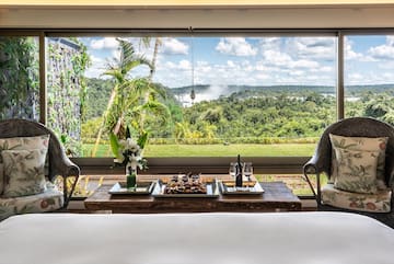 a table with food and wine in front of a window