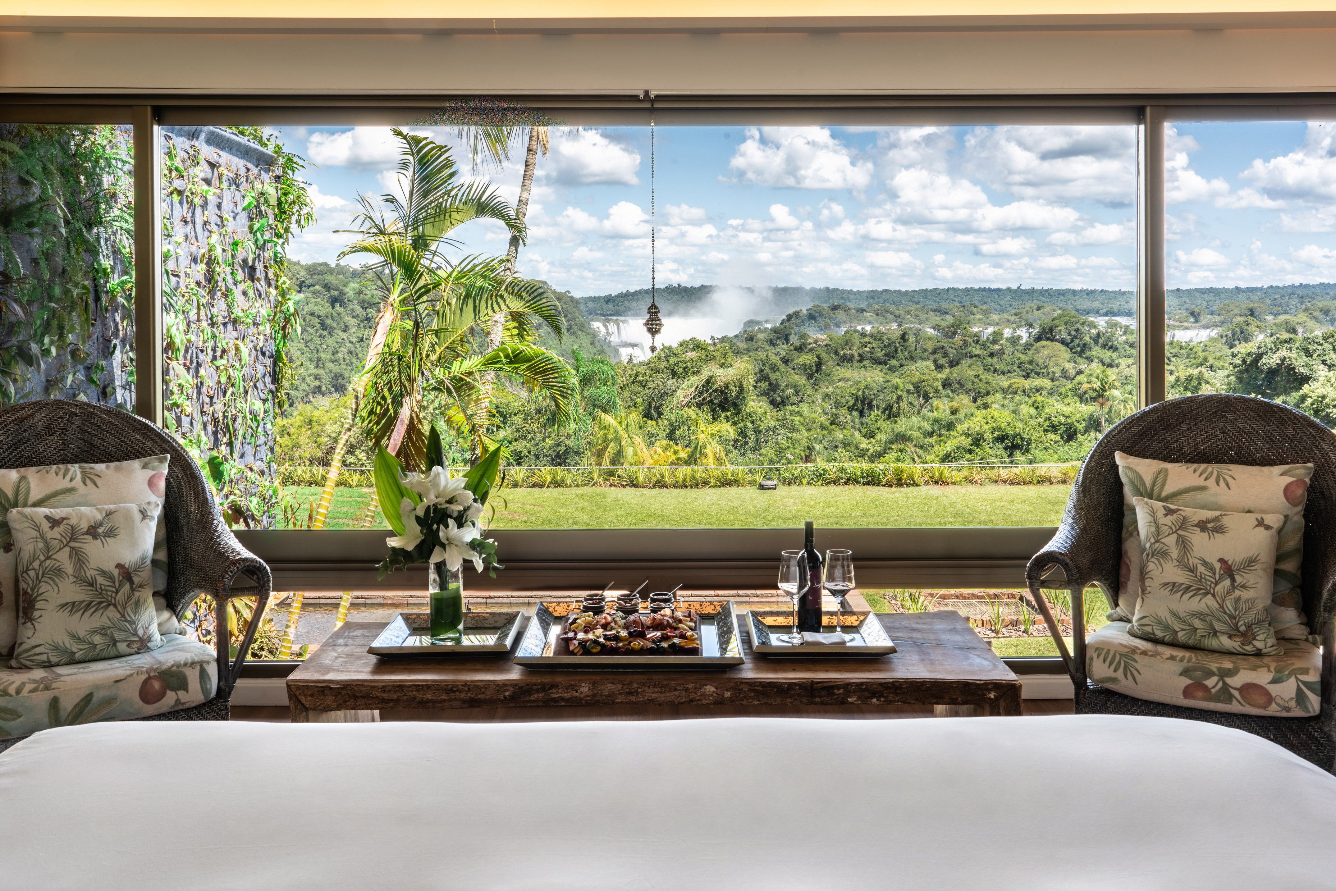a table with food and wine in front of a window