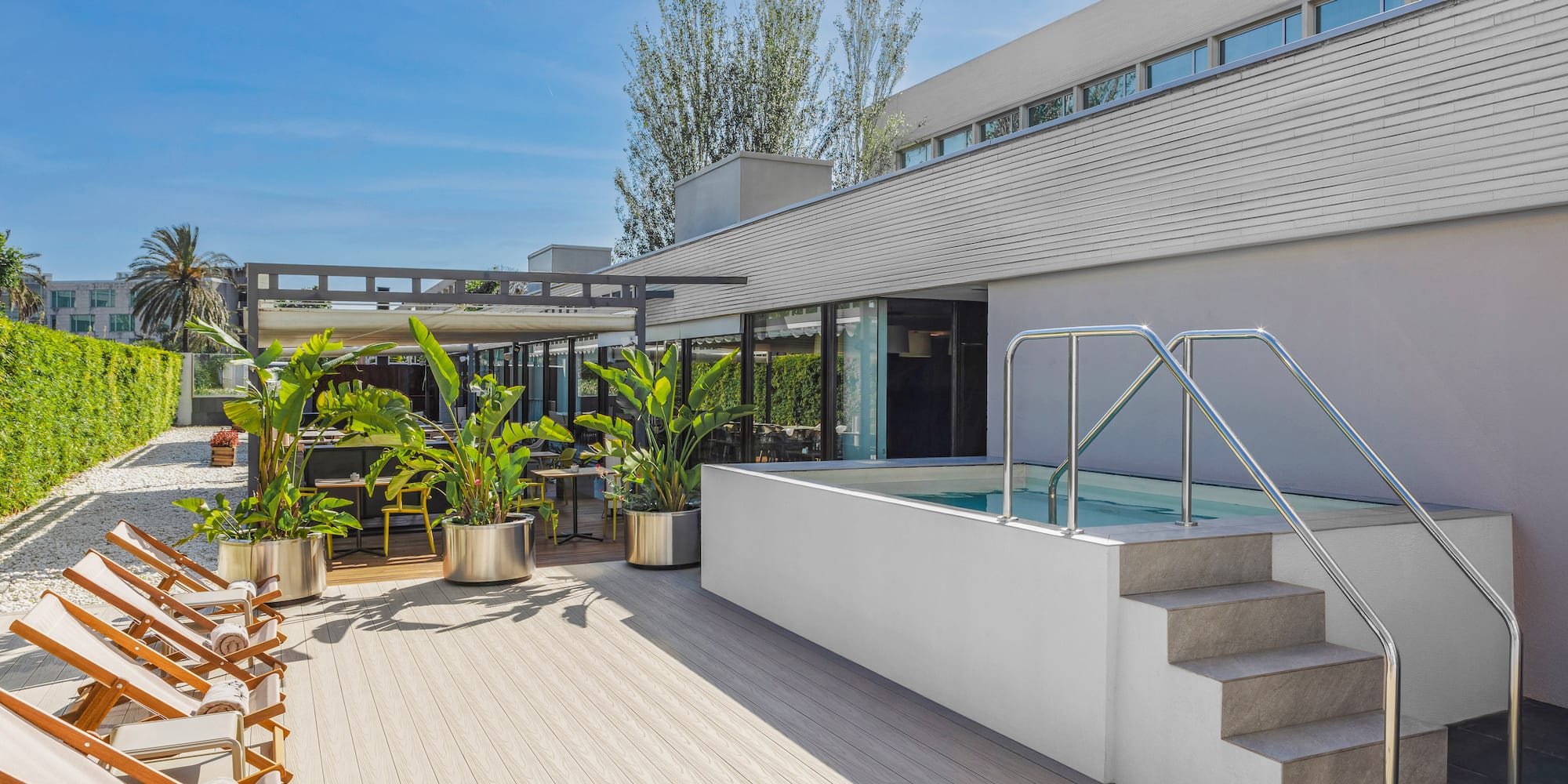 a house with a pool and plants