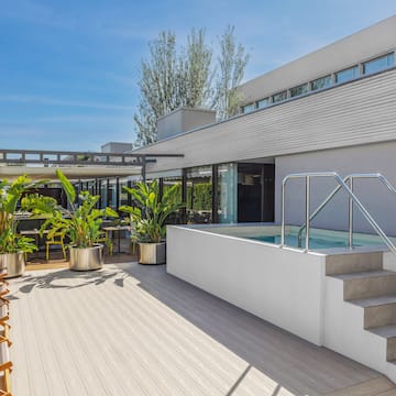 a house with a pool and plants