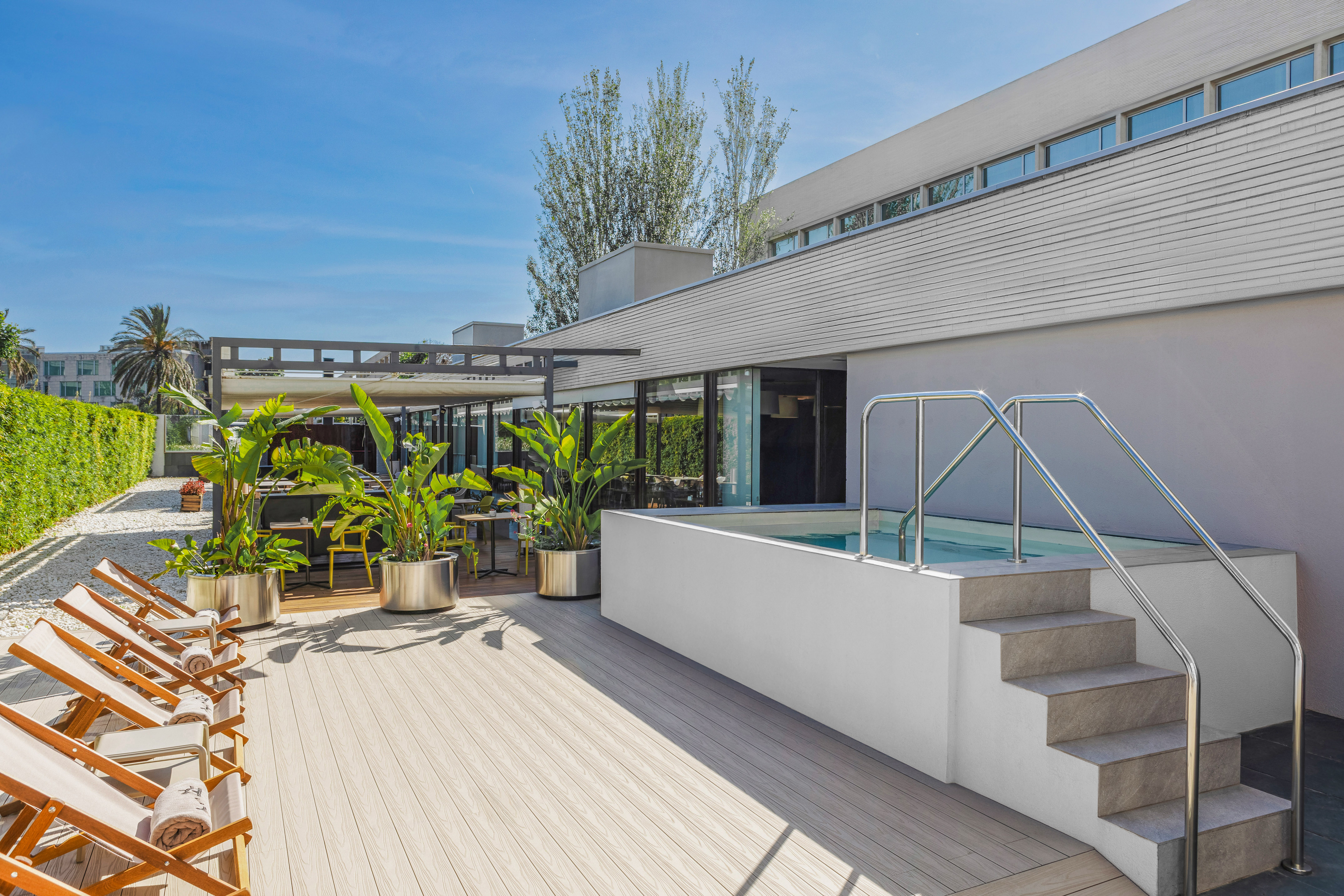 a house with a pool and plants