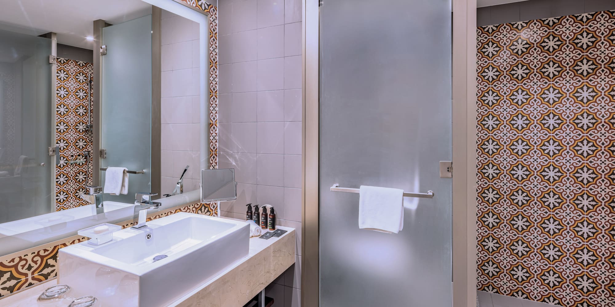 a bathroom with a glass door and a mirror