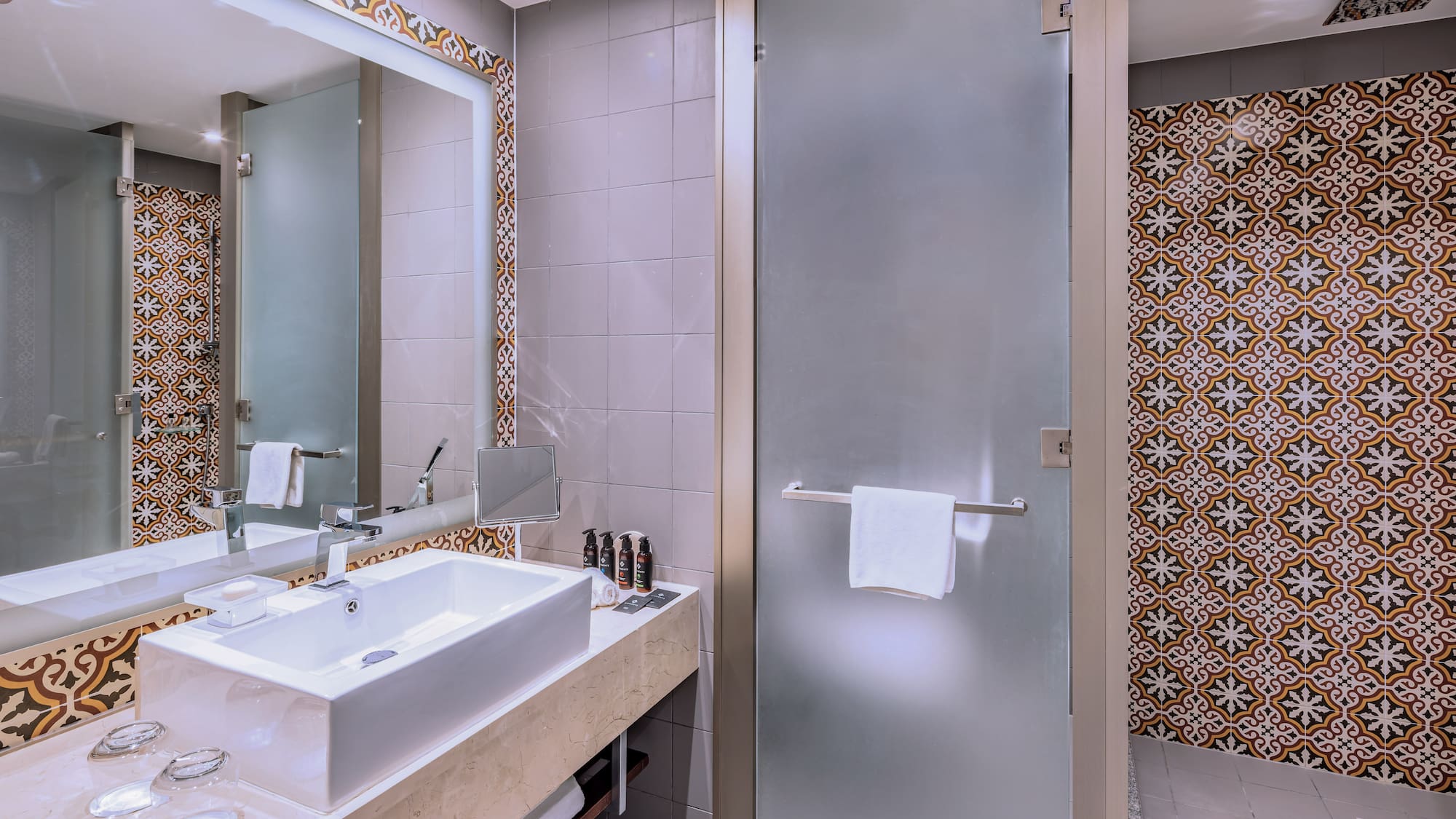 a bathroom with a glass door and a mirror