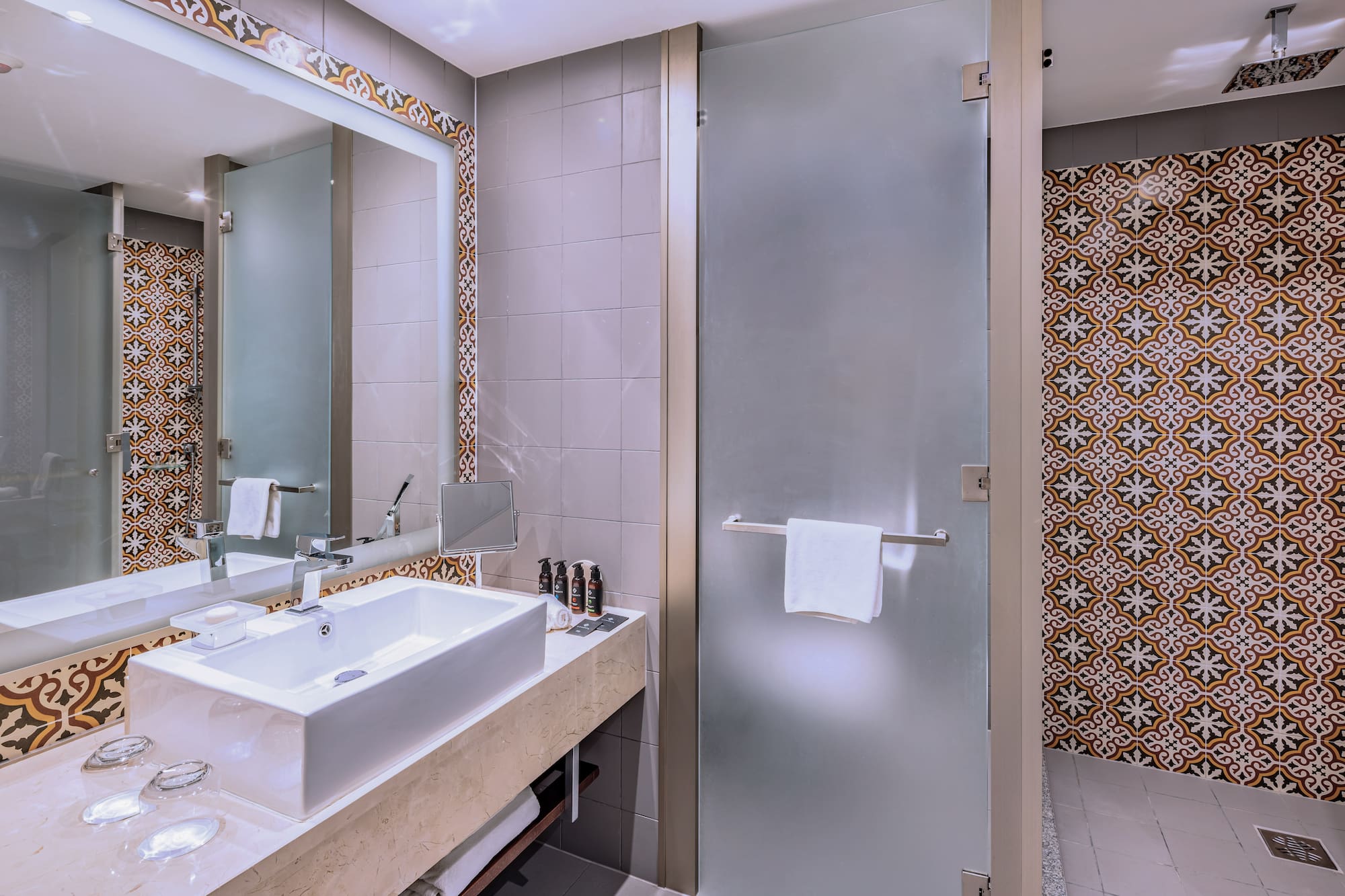 a bathroom with a glass door and a mirror