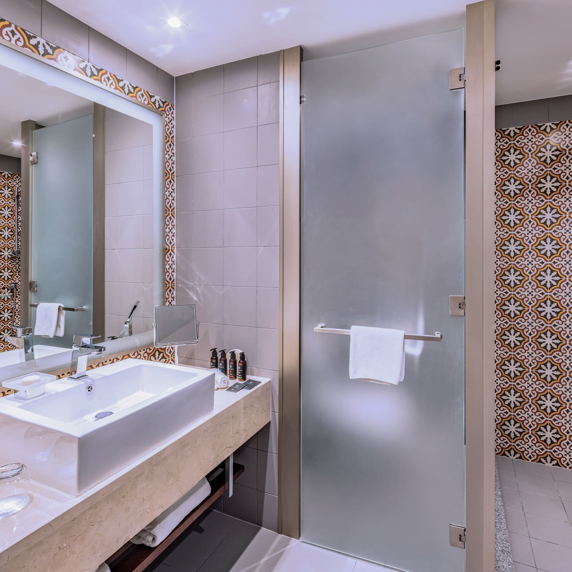 a bathroom with a glass door and a mirror