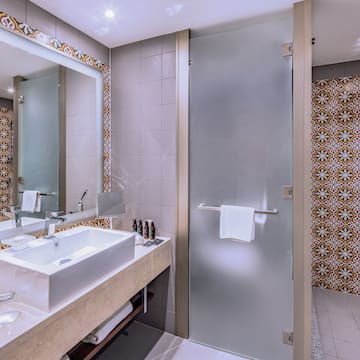 a bathroom with a glass door and a mirror