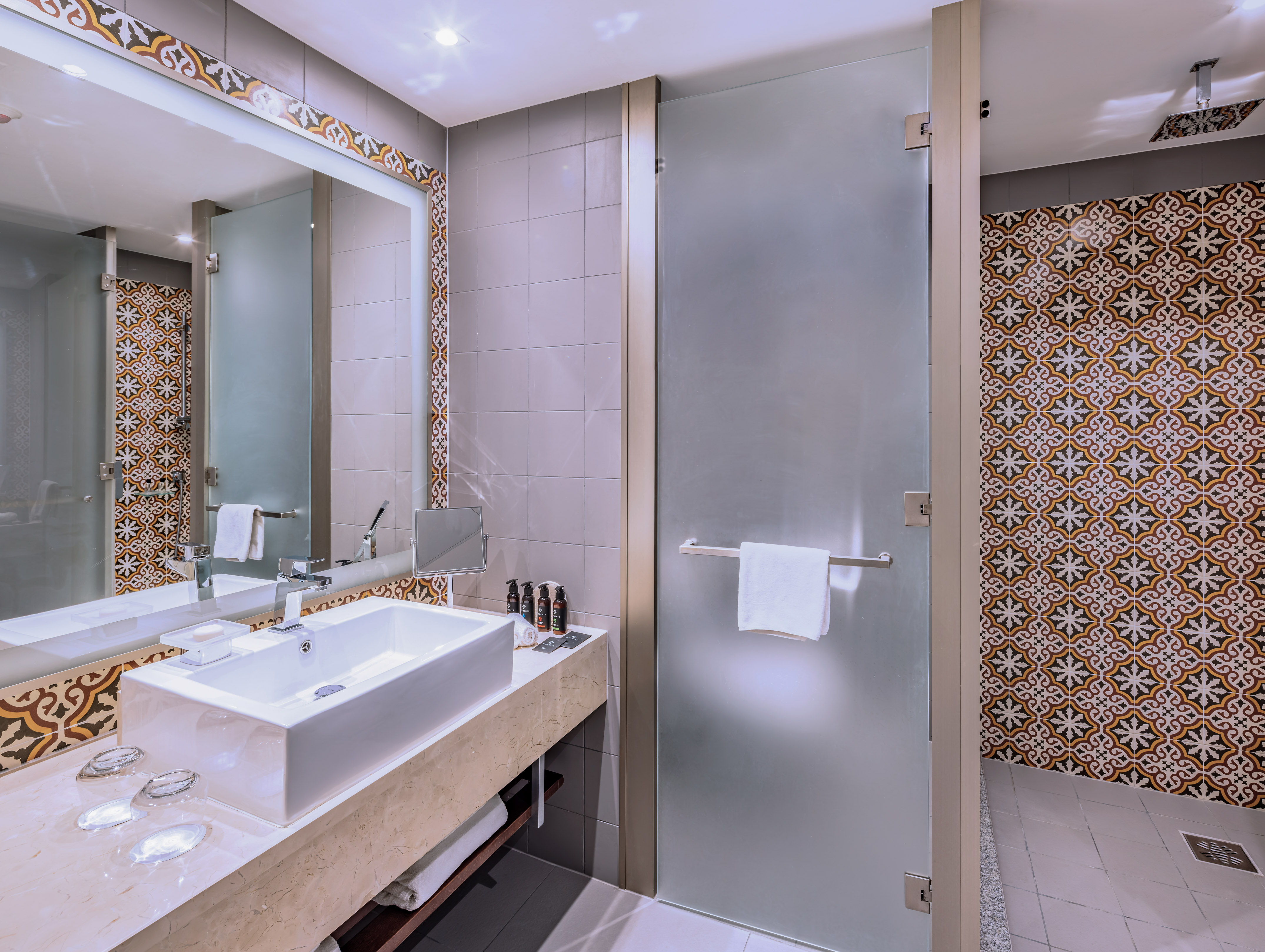 a bathroom with a glass door and a mirror