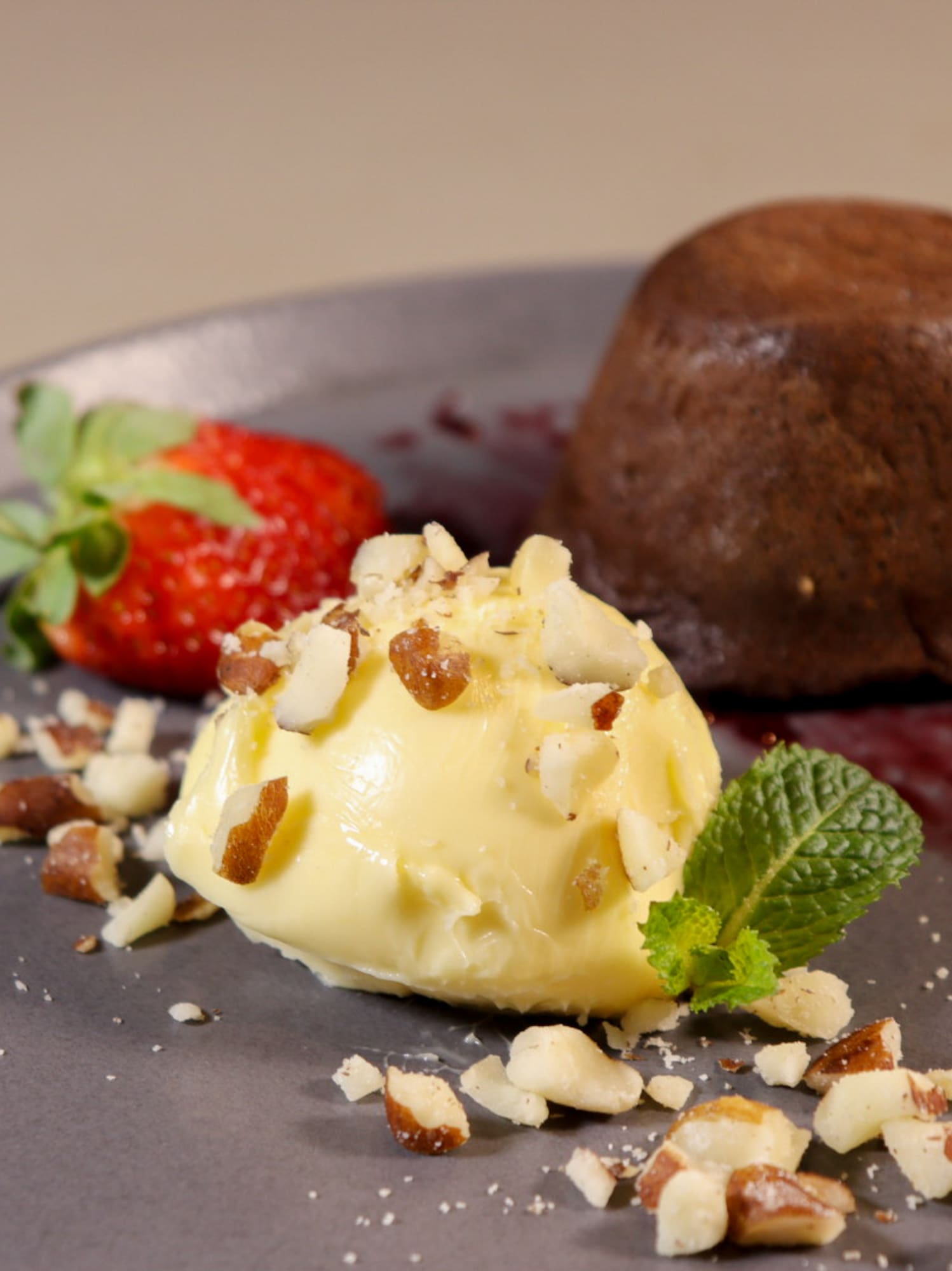 a plate of dessert with a scoop of ice cream and strawberries