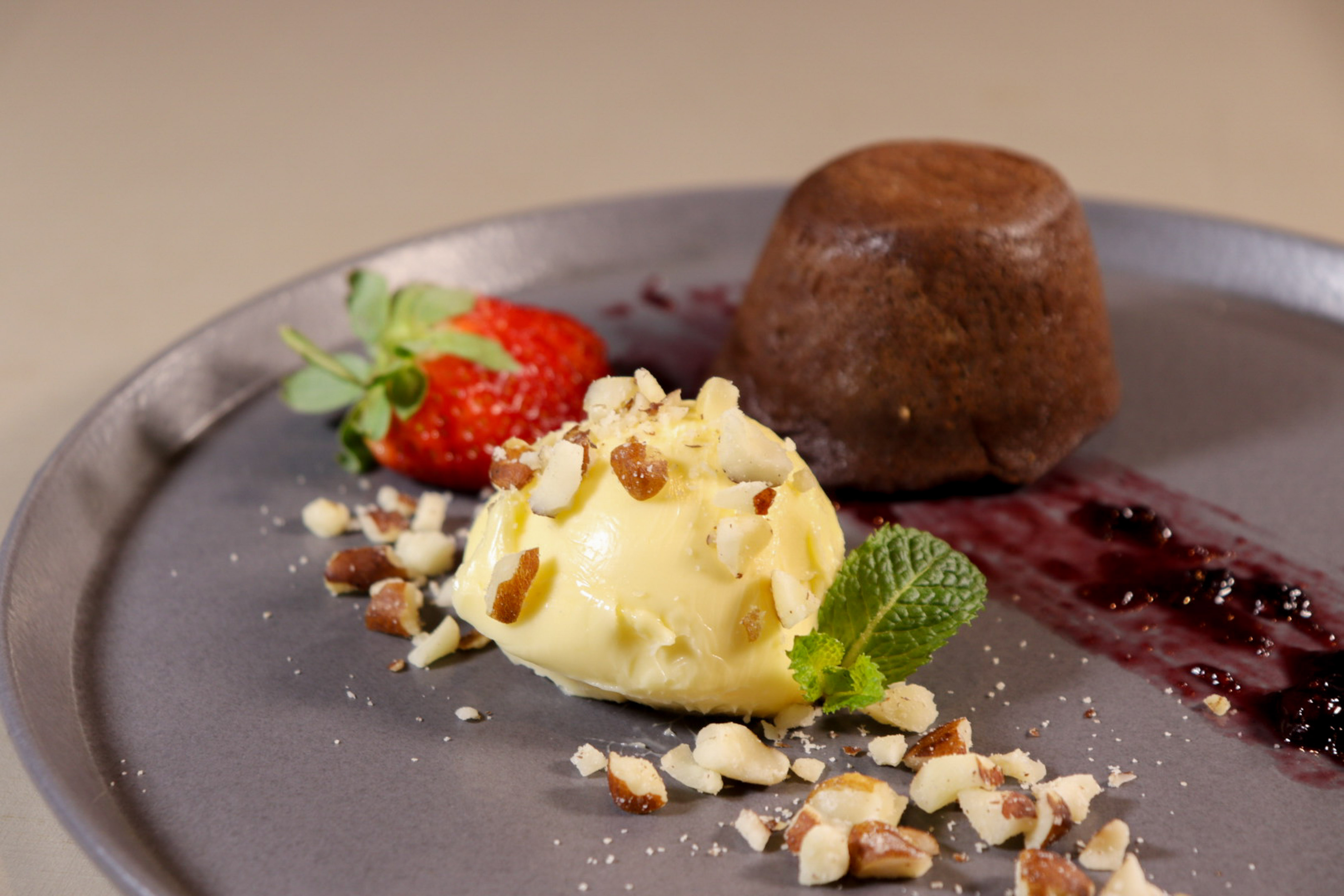 a plate of dessert with a scoop of ice cream and strawberries