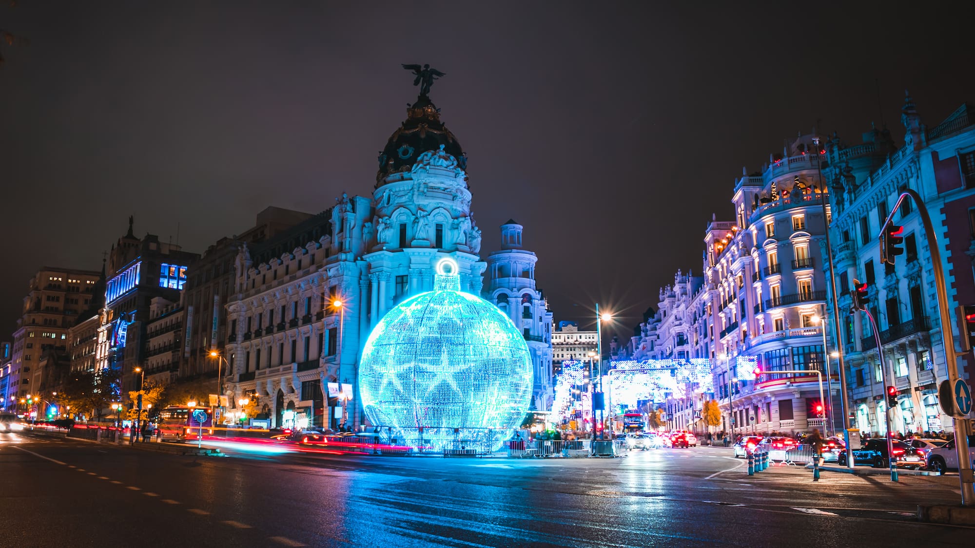 a large blue ball in front of a large building
