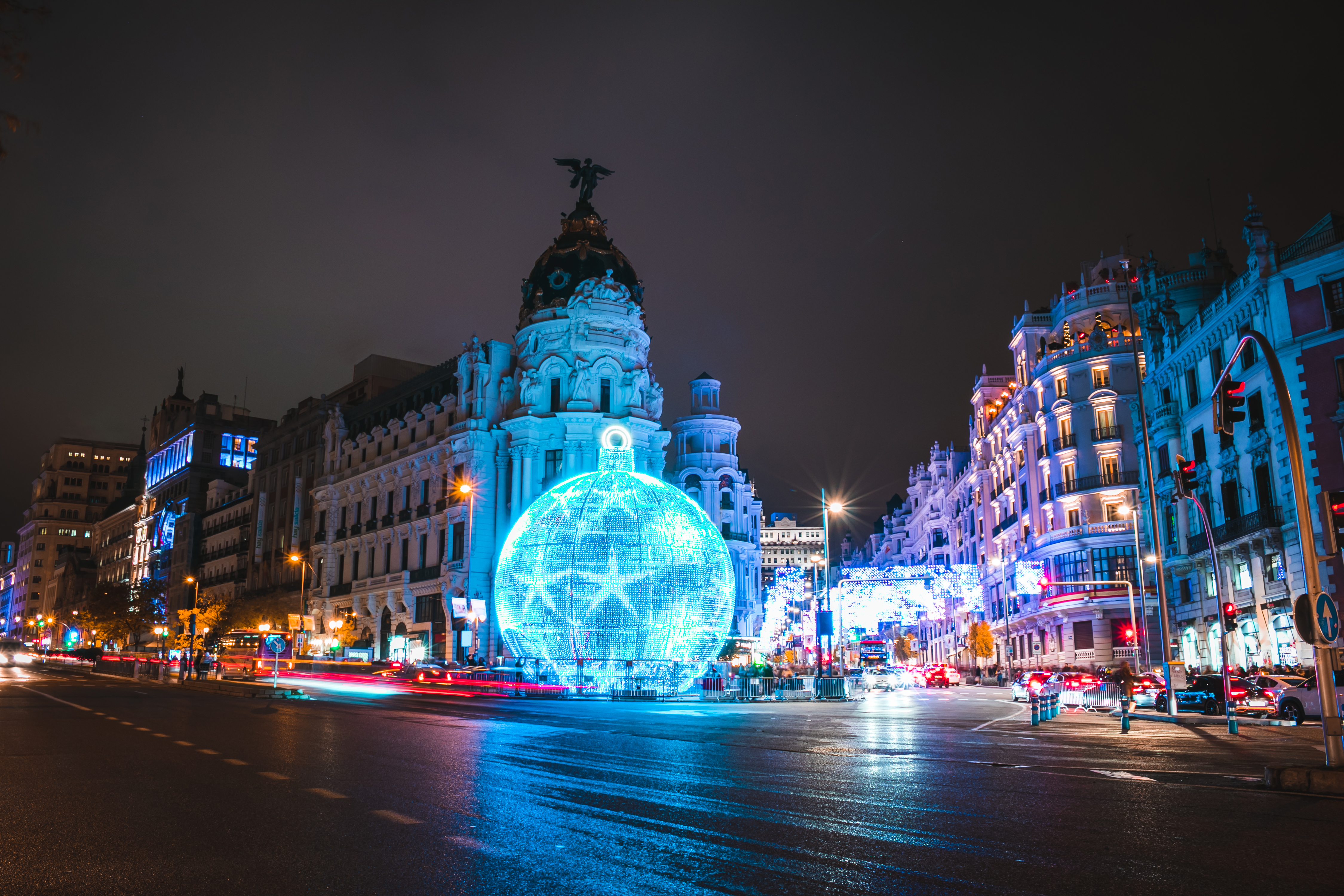 a large blue ball in front of a large building