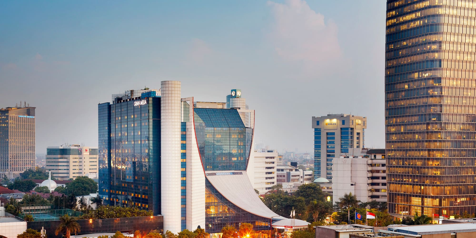 Gran Meliá Jakarta hotel and modern city skyline at dusk