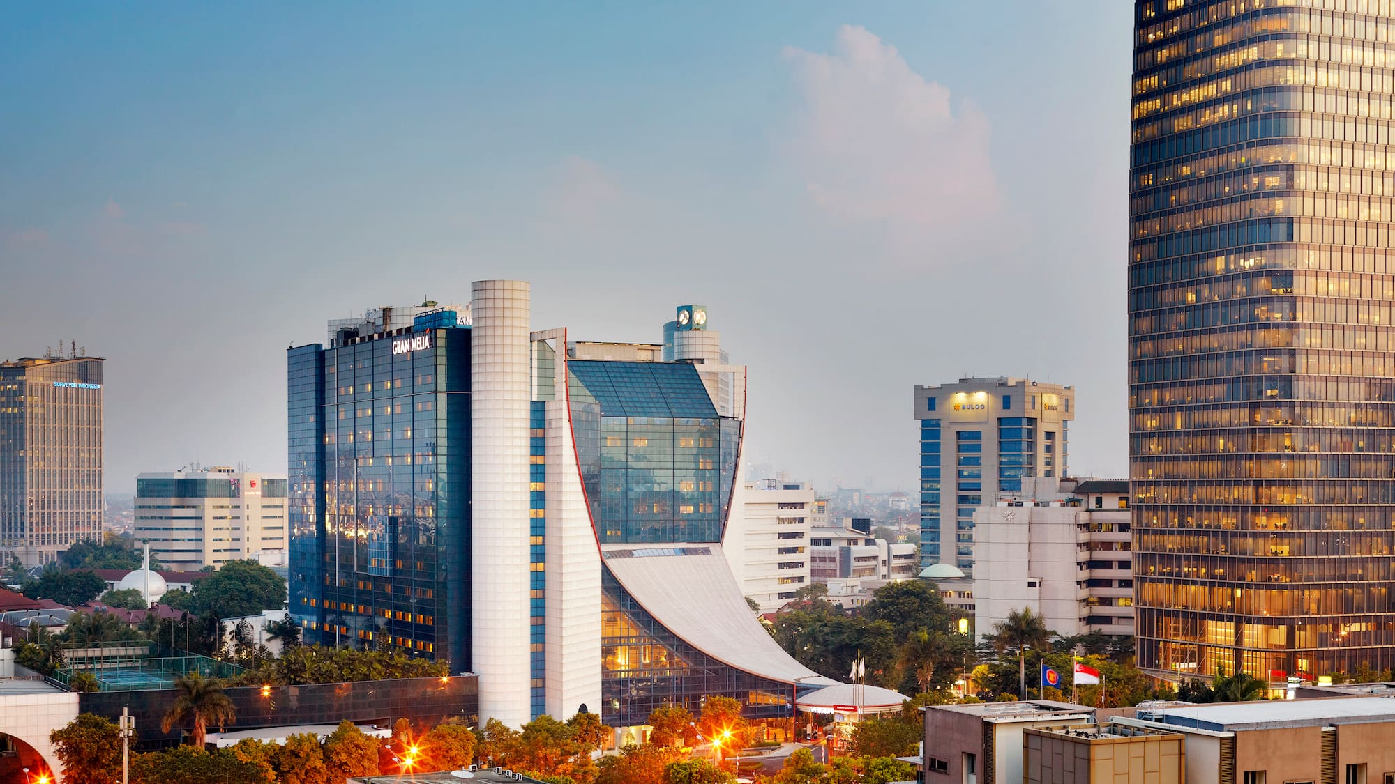 Gran Meliá Jakarta hotel and modern city skyline at dusk