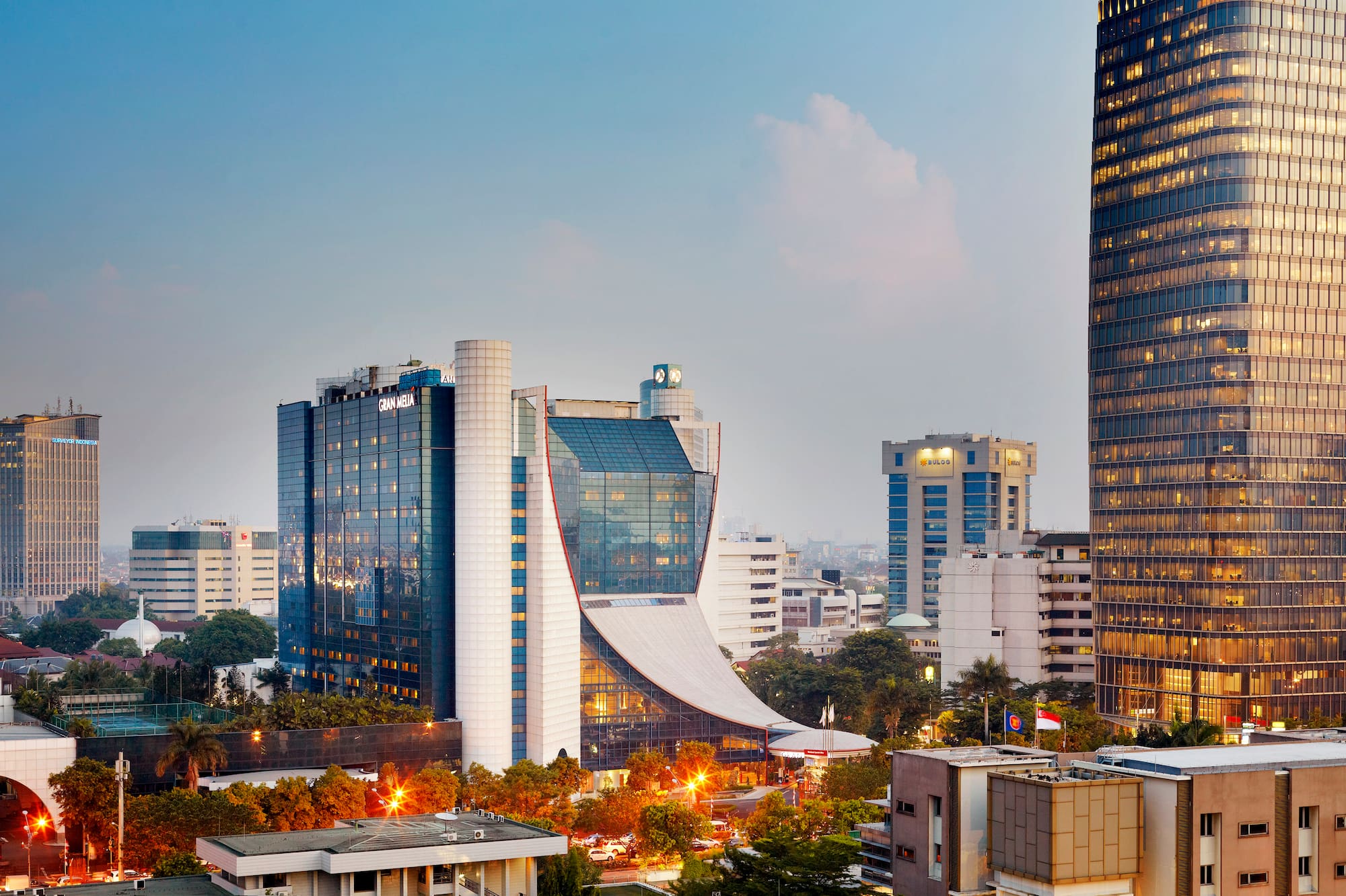 Gran Meliá Jakarta hotel and modern city skyline at dusk