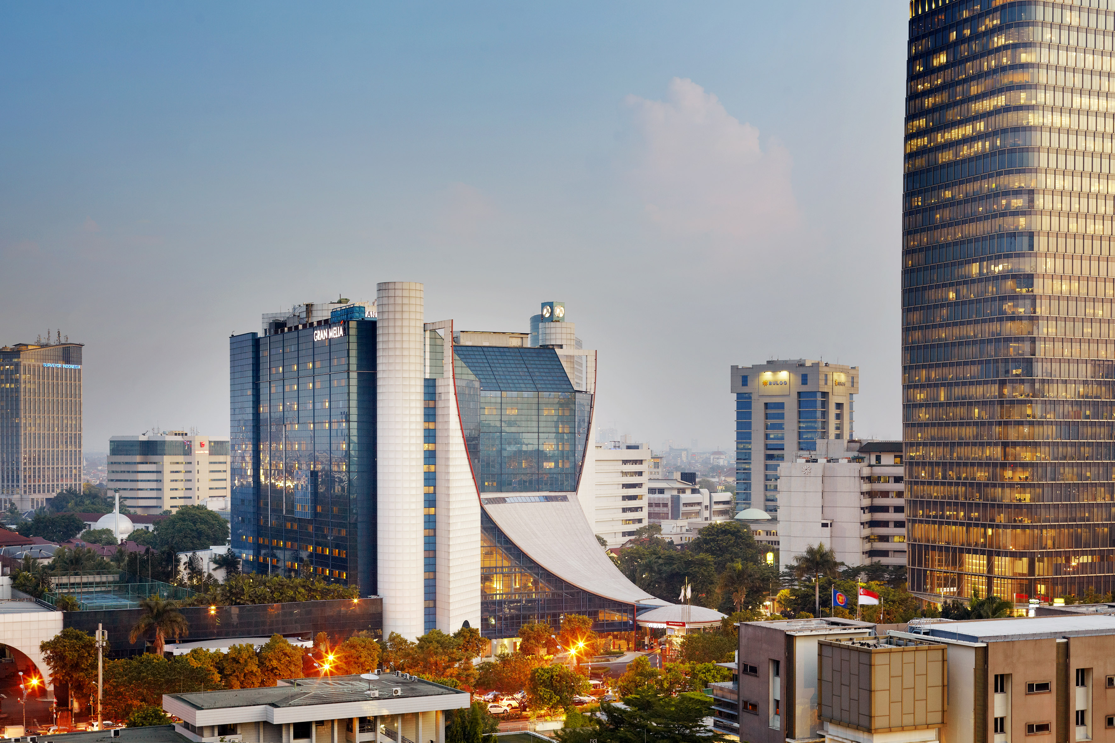 Gran Meliá Jakarta hotel and modern city skyline at dusk