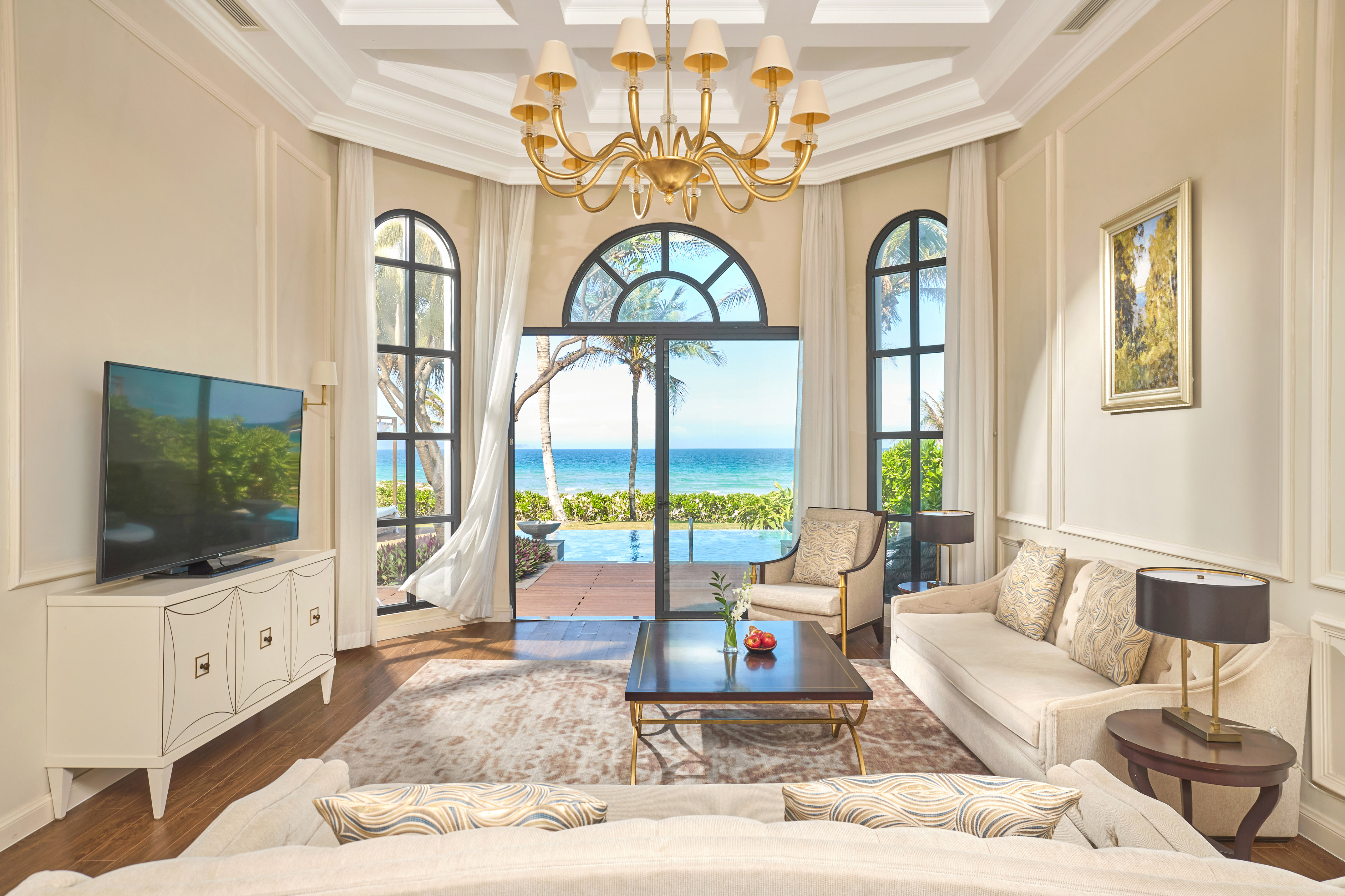 a living room with a large window overlooking the ocean