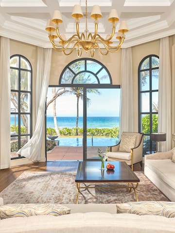 a living room with a large window overlooking the ocean