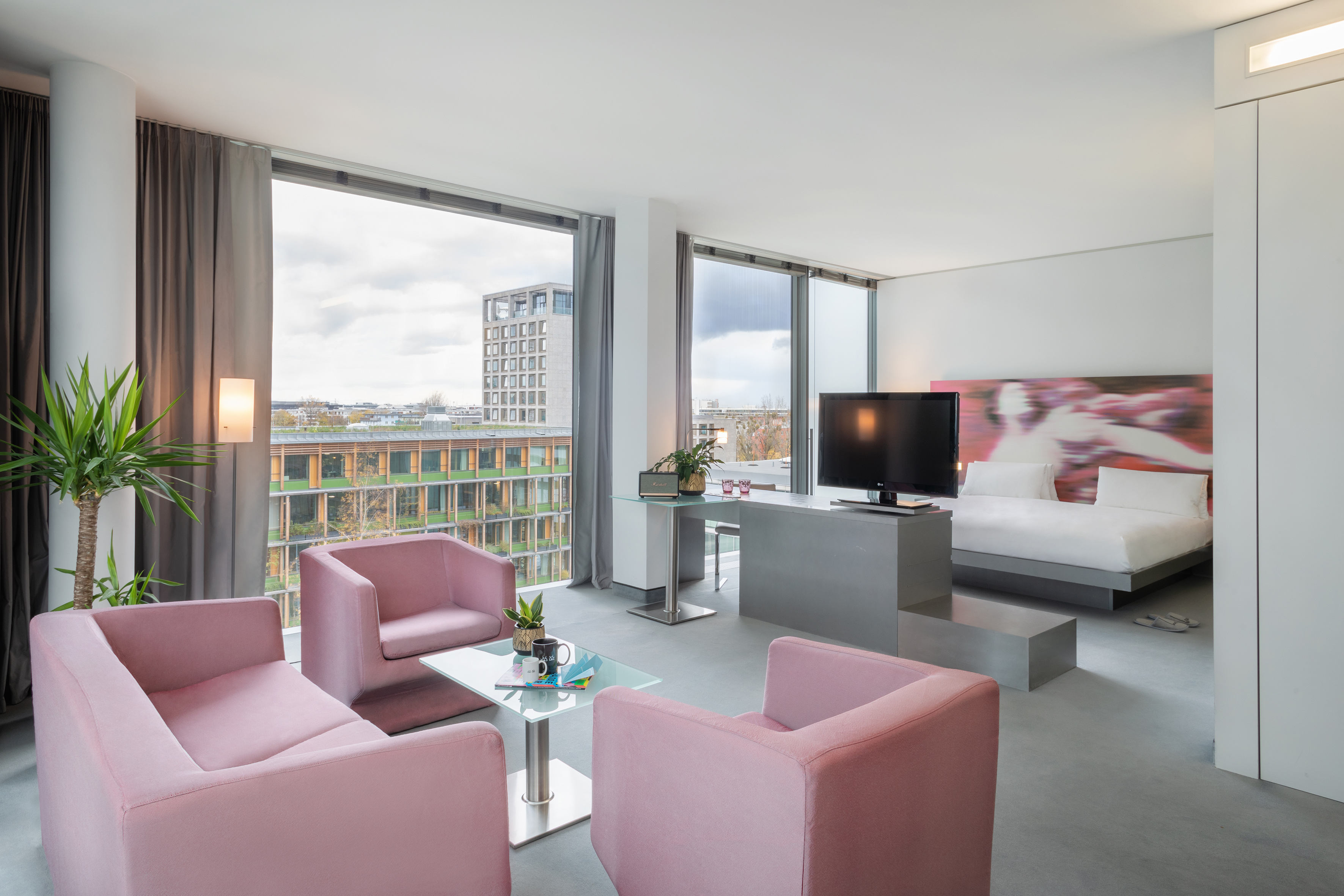 a room with pink chairs and a tv