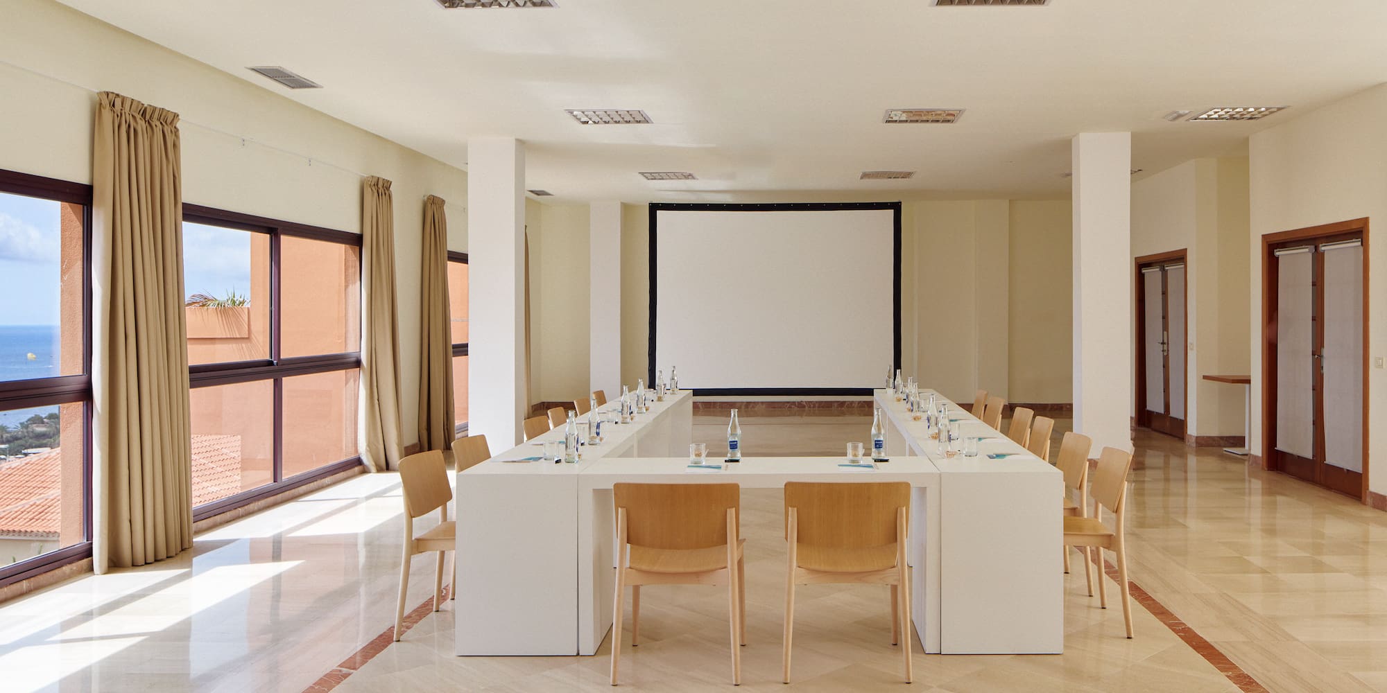 a room with a large table and chairs