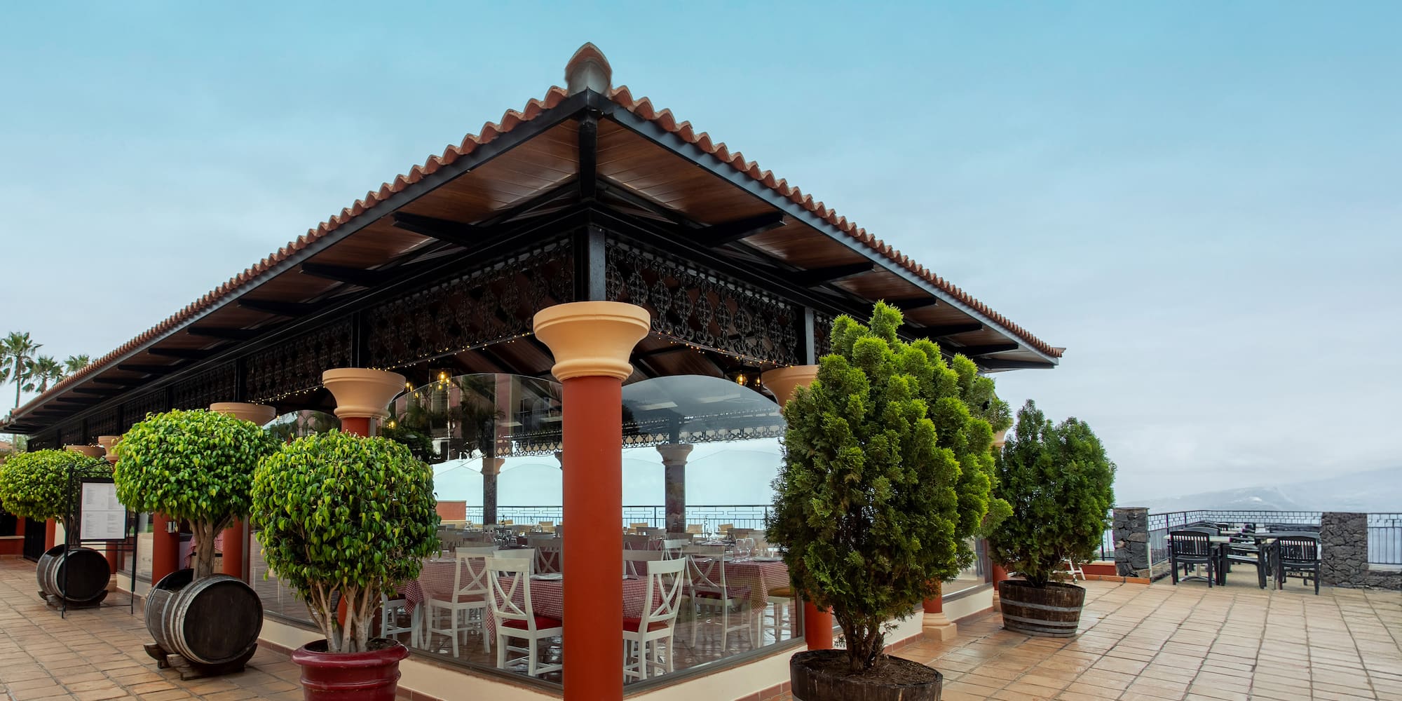 a building with a roof and trees