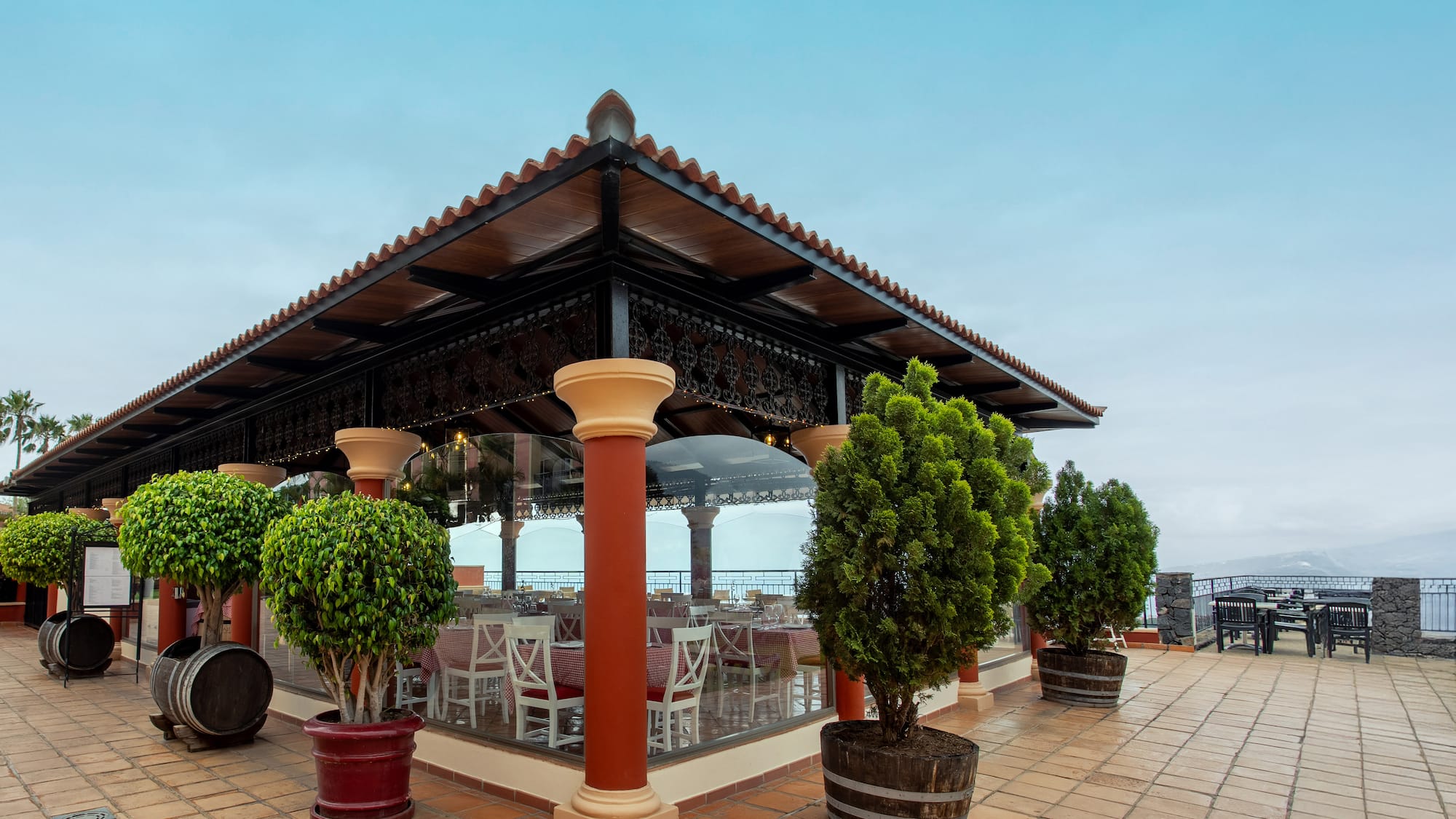 a building with a roof and trees