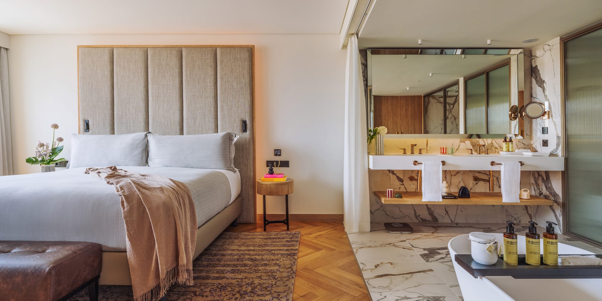 a bedroom with a large bed and a bathtub