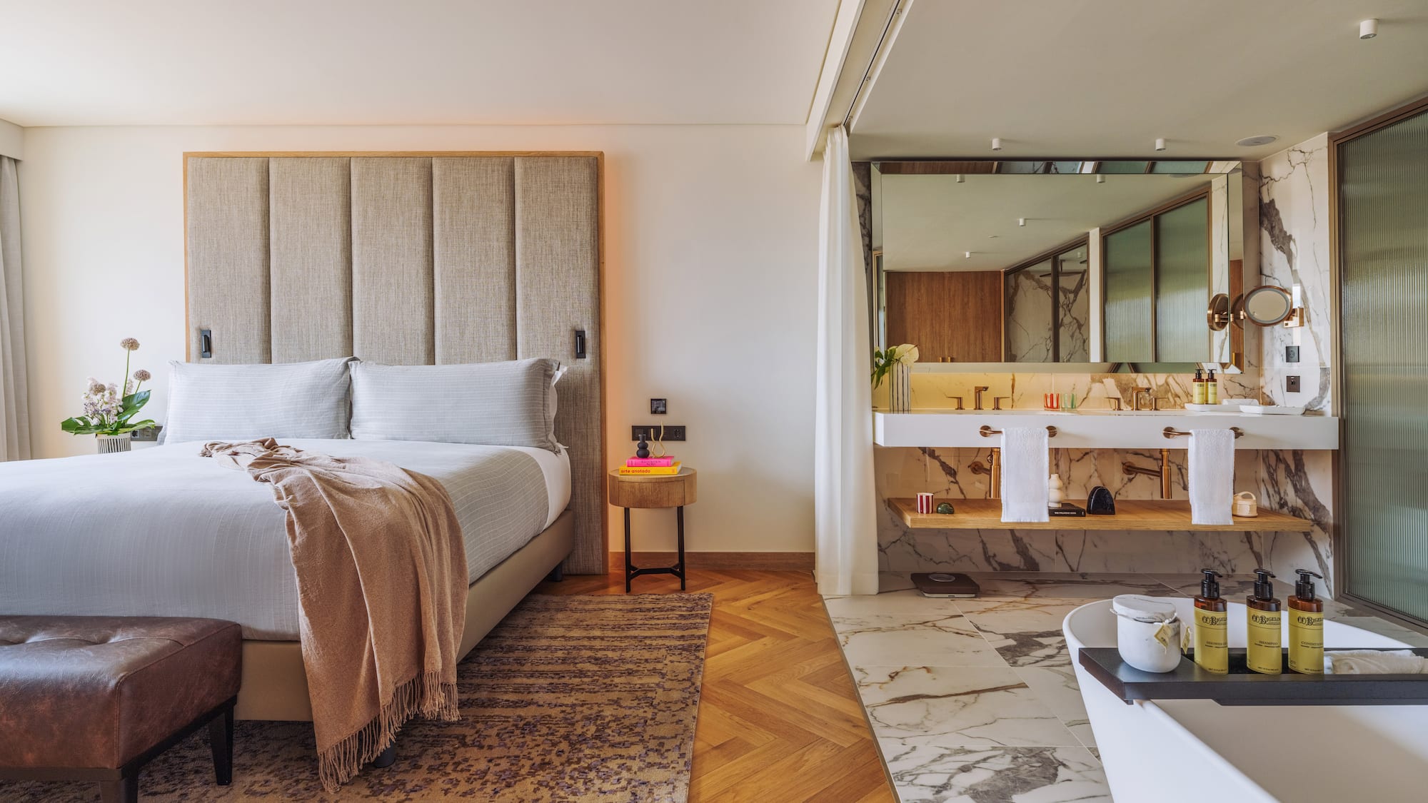 a bedroom with a large bed and a bathtub