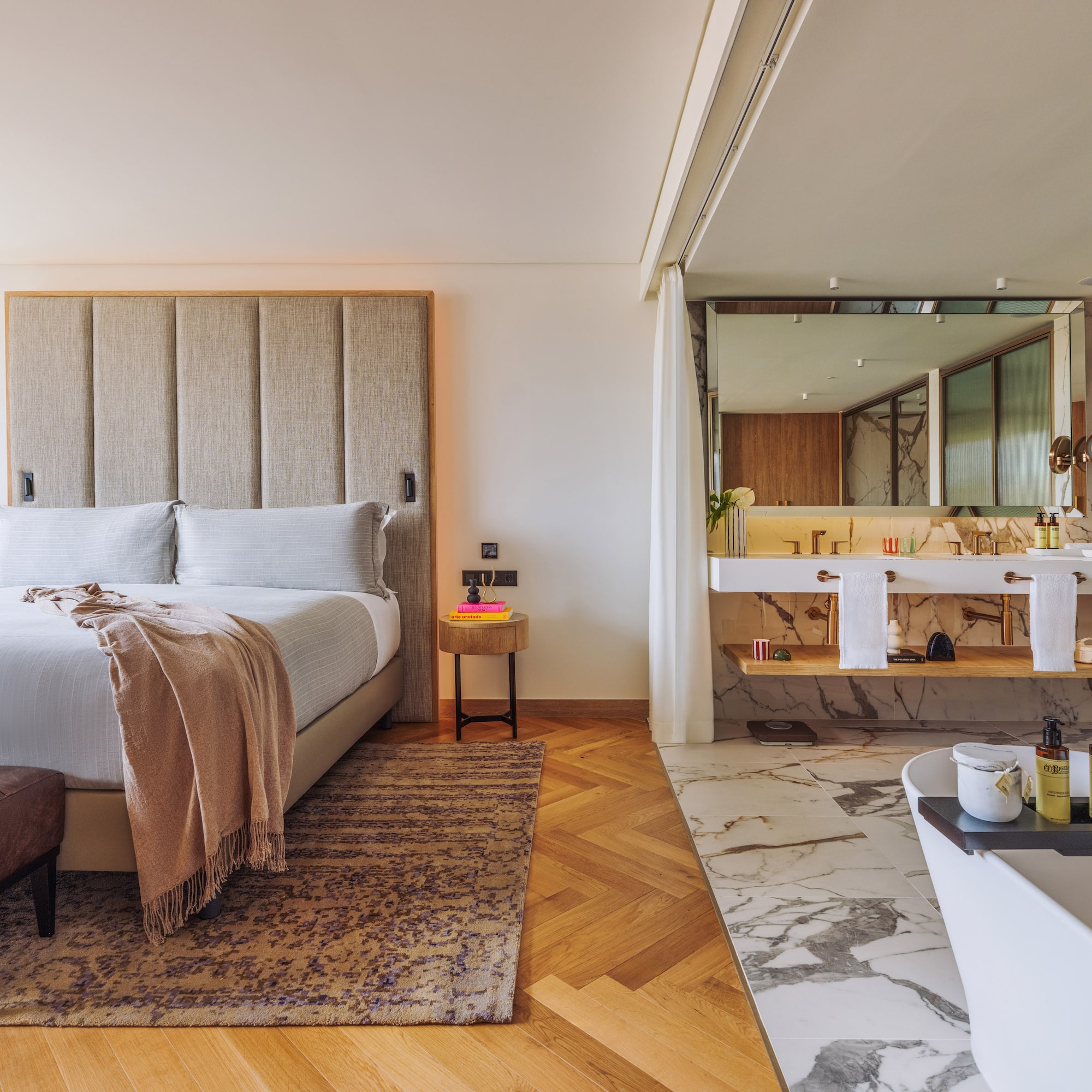 a bedroom with a large bed and a bathtub