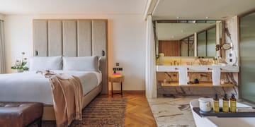 a bedroom with a large bed and a bathtub