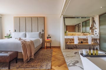 a bedroom with a large bed and a bathtub