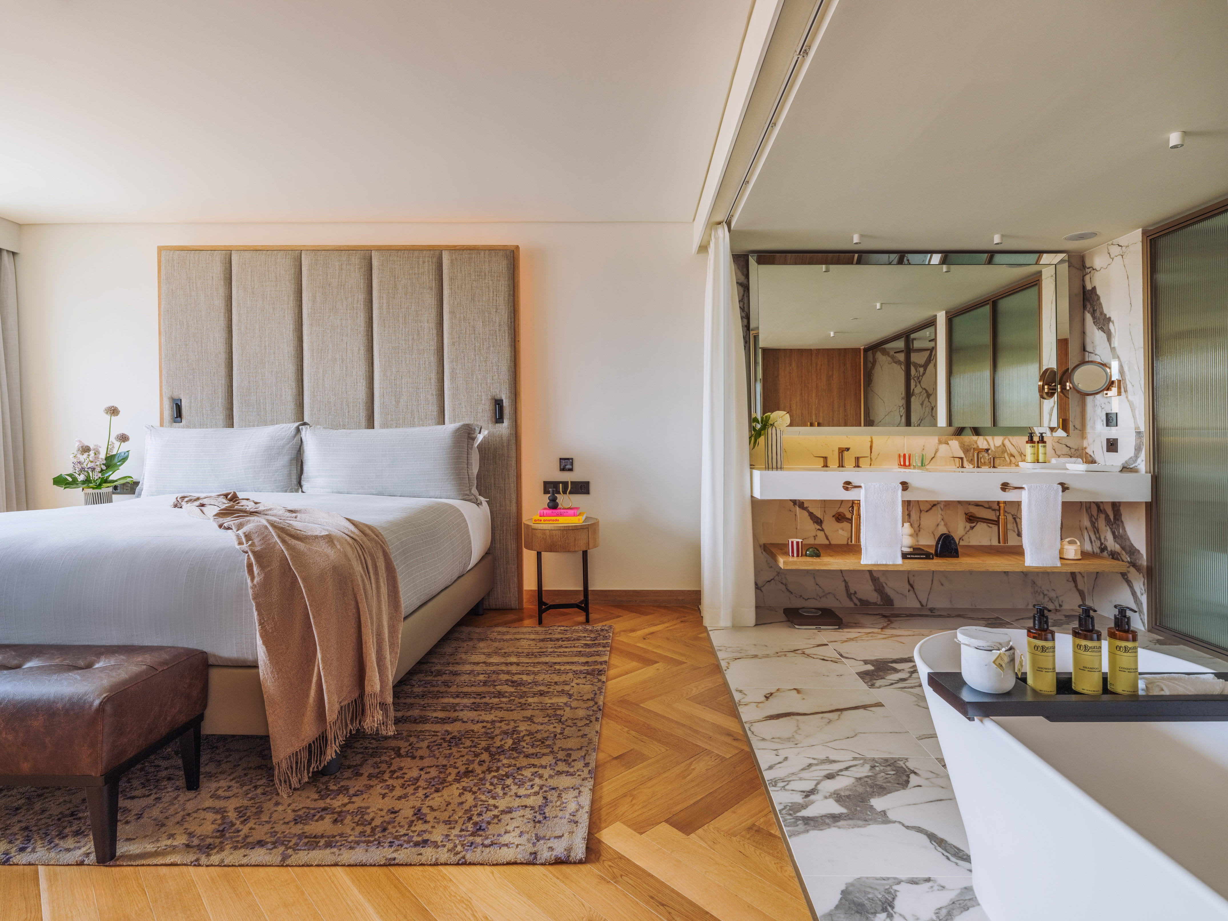 a bedroom with a large bed and a bathtub