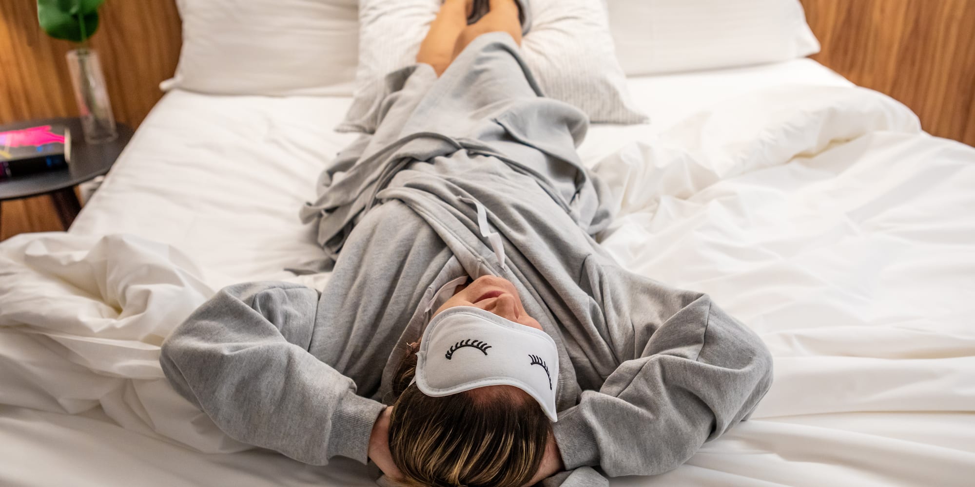 a woman lying on a bed with her head on her face