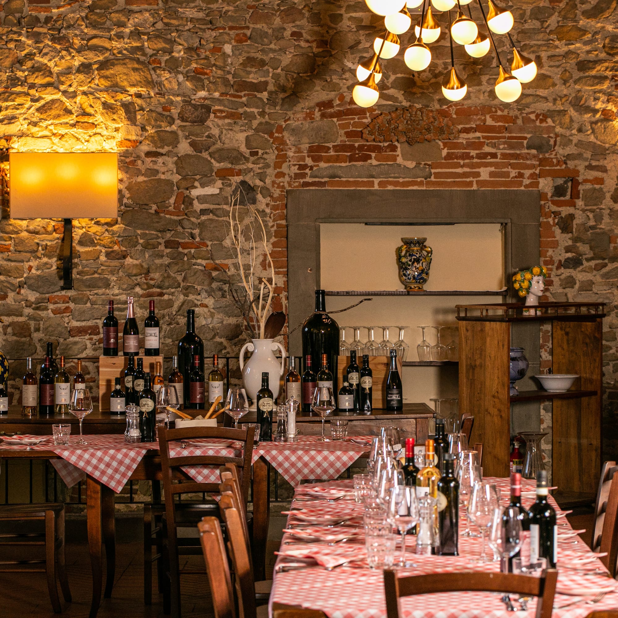 a table with wine bottles and glasses on it