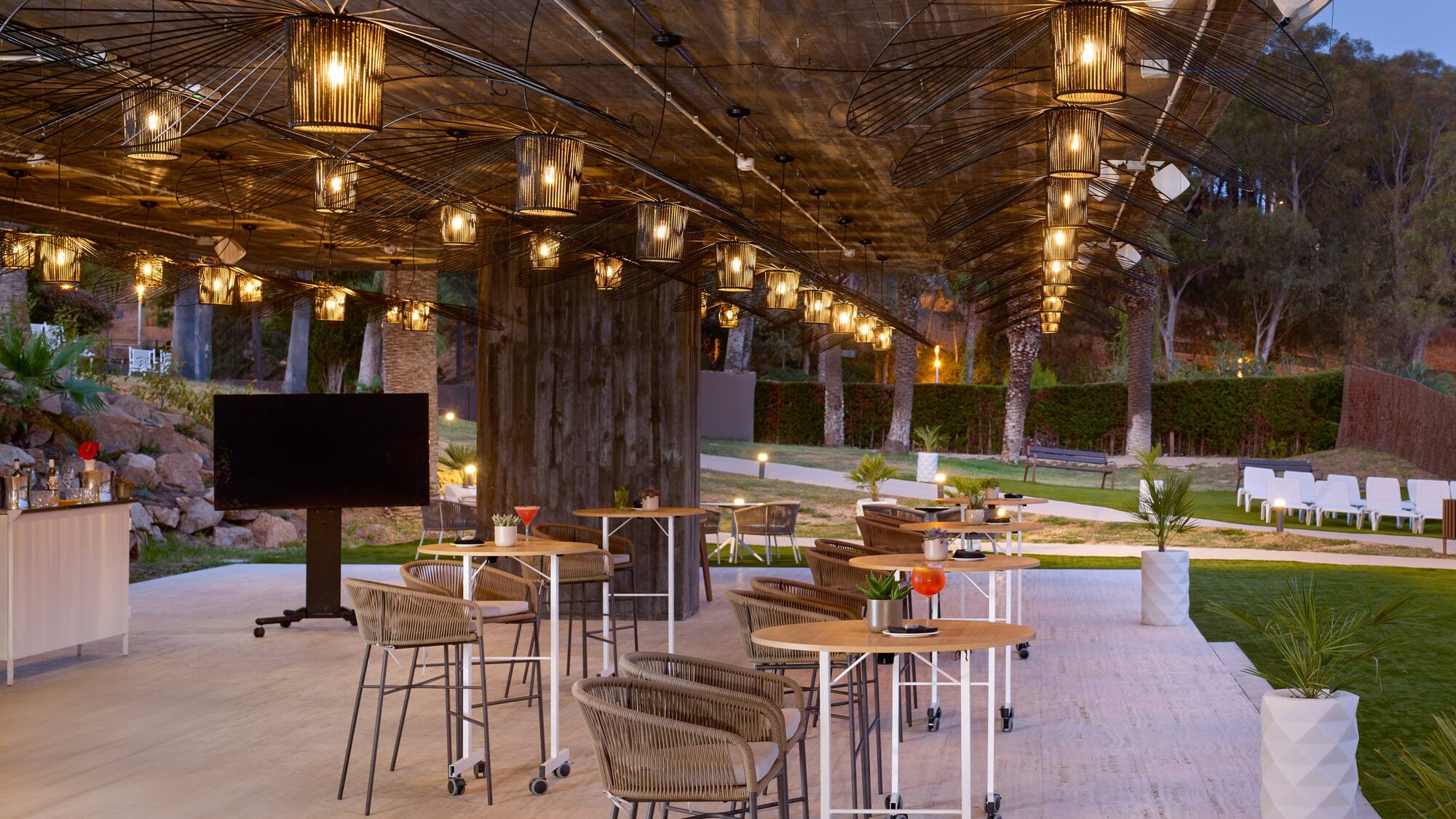a patio with tables and chairs and a television