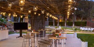 a patio with tables and chairs and a television