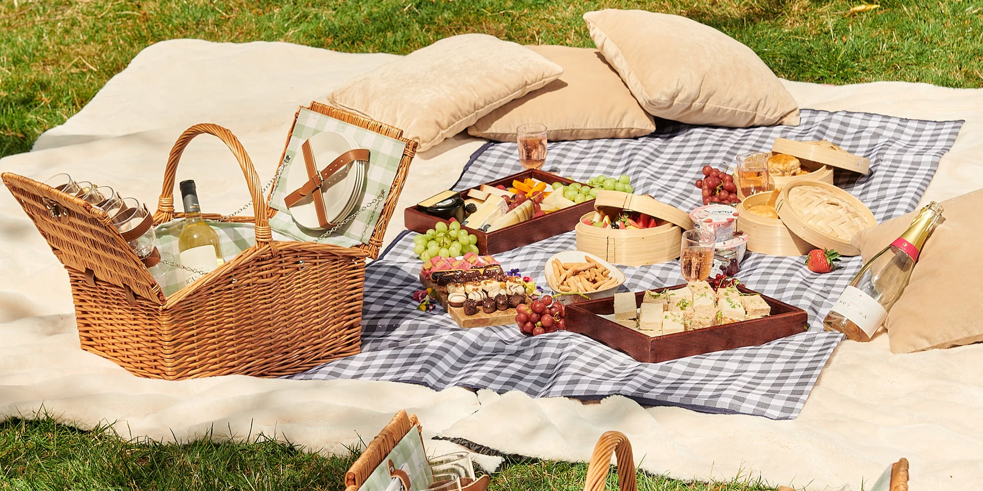 picnic blanket with food and drinks on it