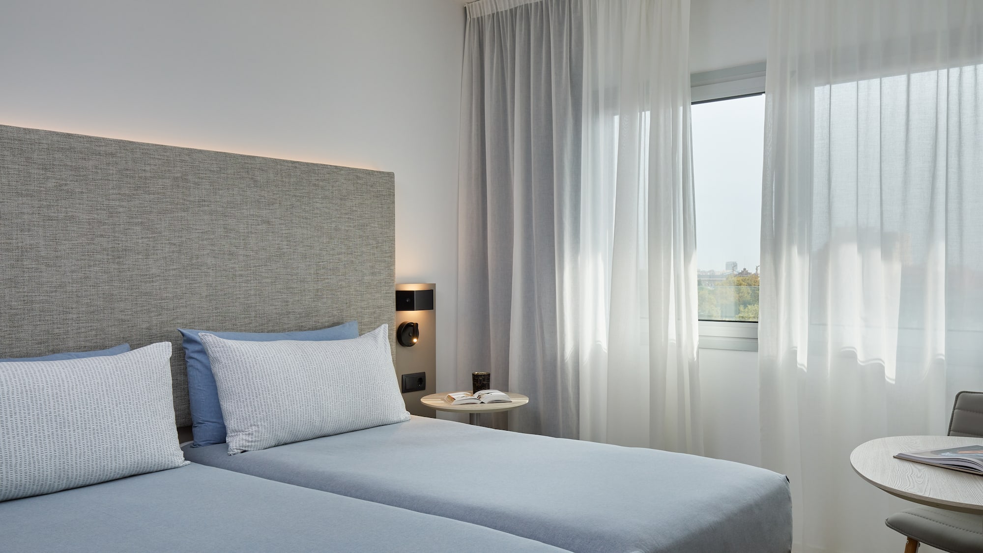 a bedroom with two beds and a window