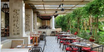 a patio with tables and chairs