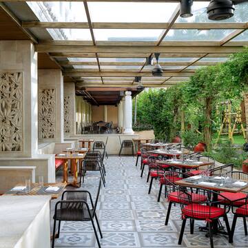 a patio with tables and chairs