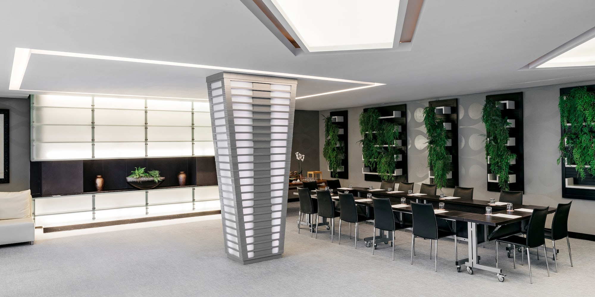 a room with a large pedestal and chairs