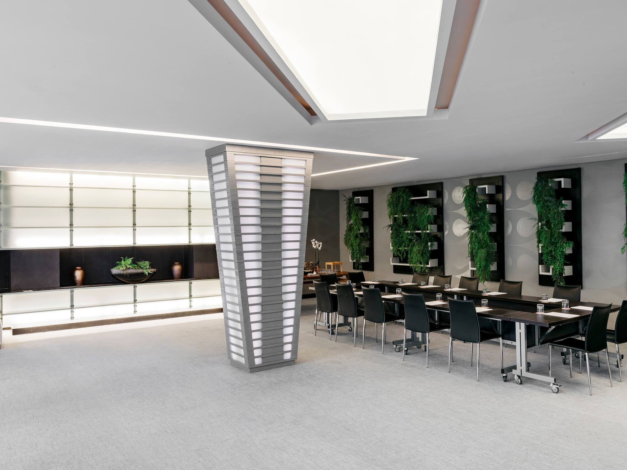 a room with a large pedestal and chairs